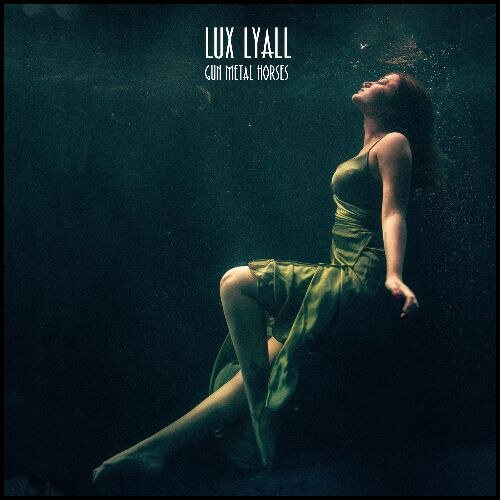 Noir-pop artist Lux Lyall shares 'Gun Metal Horses' + poem 'A Stitch'